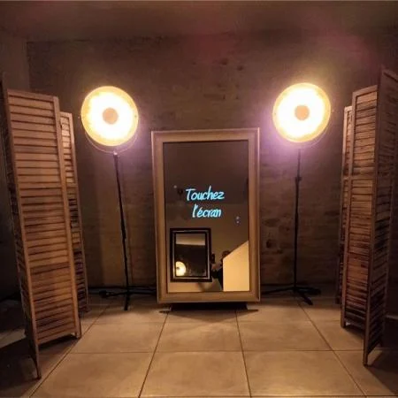 Photobooth miroir « Touchez l’écran » entre deux projecteurs et des paravents en bois